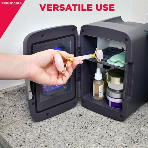 Open mini fridge on countertop with skincare items inside.