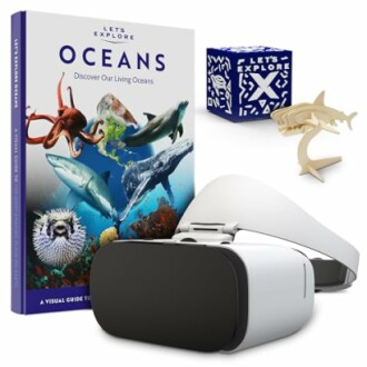 Ocean exploration book, VR headset, cube, and shark model.